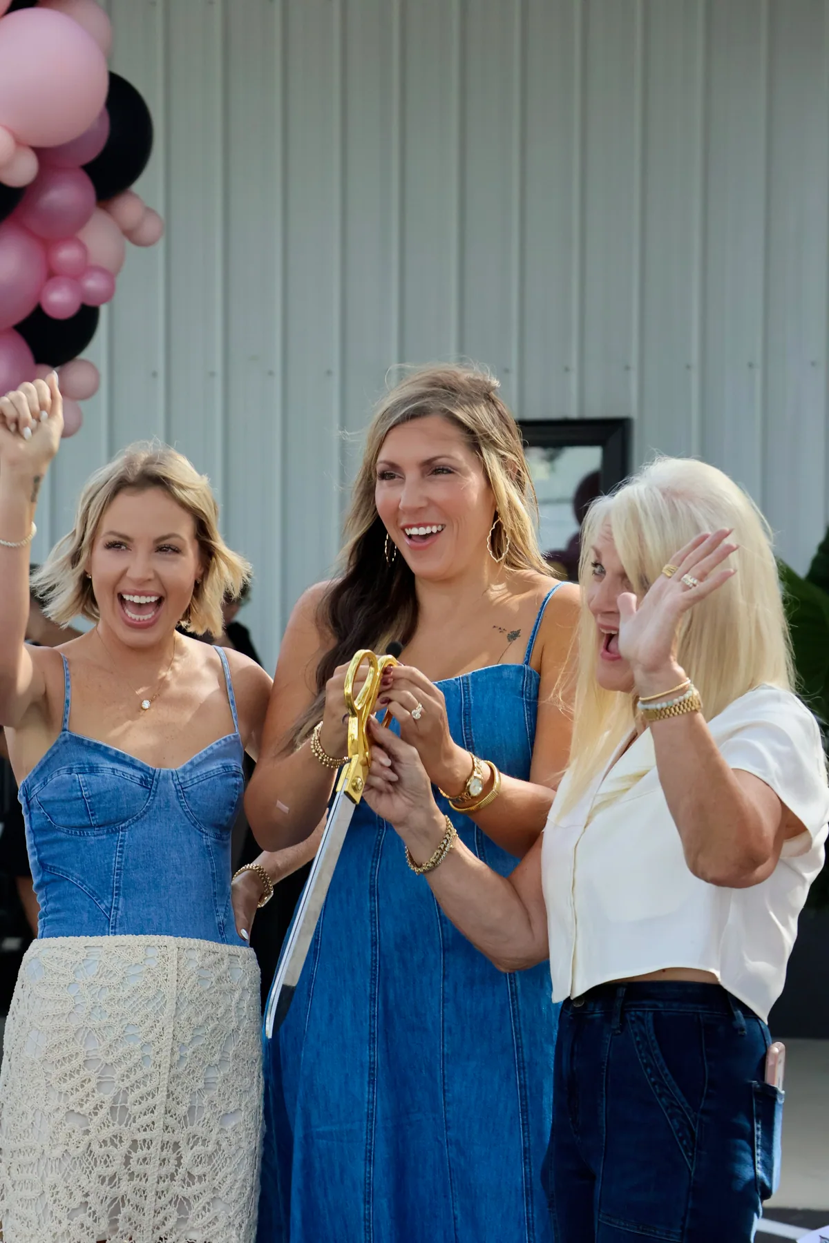 Dandelion Wishes owners celebrating with ceremonial scissors